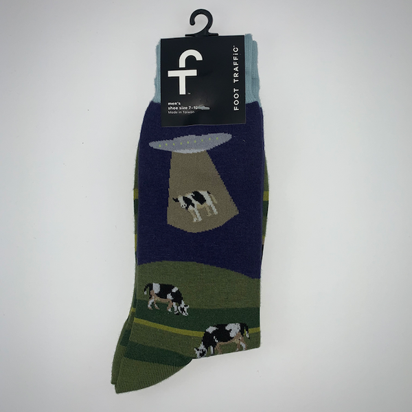 Navy and green socks featuring cows being abucted by aliens